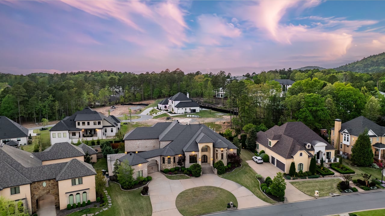 Aerial front view of 106 Orle Drive with circular drive, detached garage, and landscaped lot.