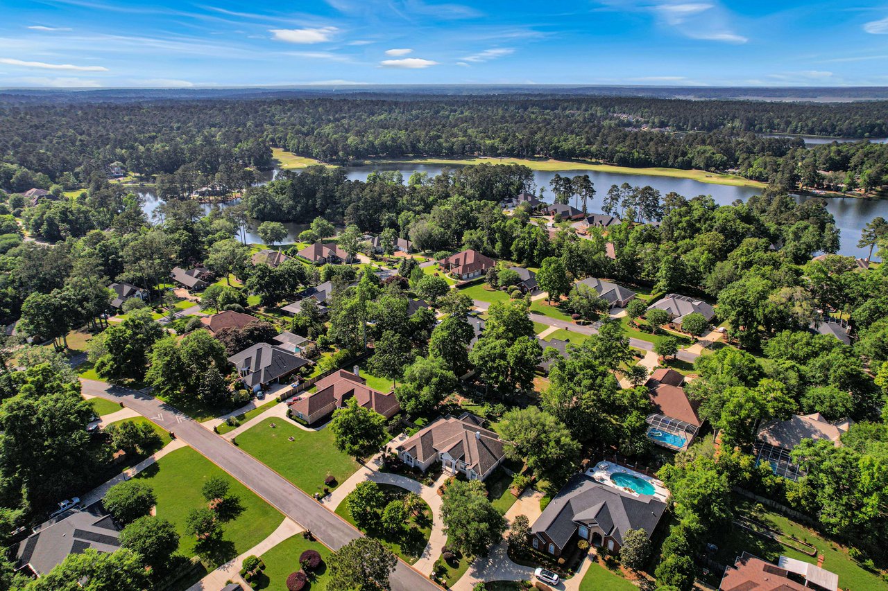 Another aerial view of Golden Eagle, showing the layout of houses, a lake, and surrounding greenery.