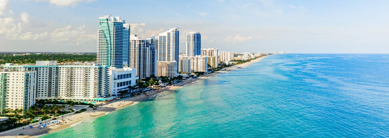 Aerial view of Hallandale Beach, Florida with high-rise condos along the oceanfront shoreline.