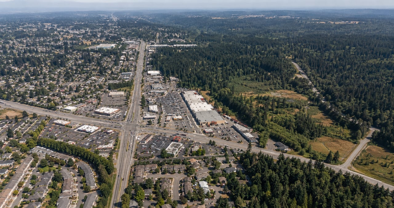 Aerial view near Four Corners in Maple Valley, Washington, showing roads, commercial areas, trees, and land near the Summit Place planning area.