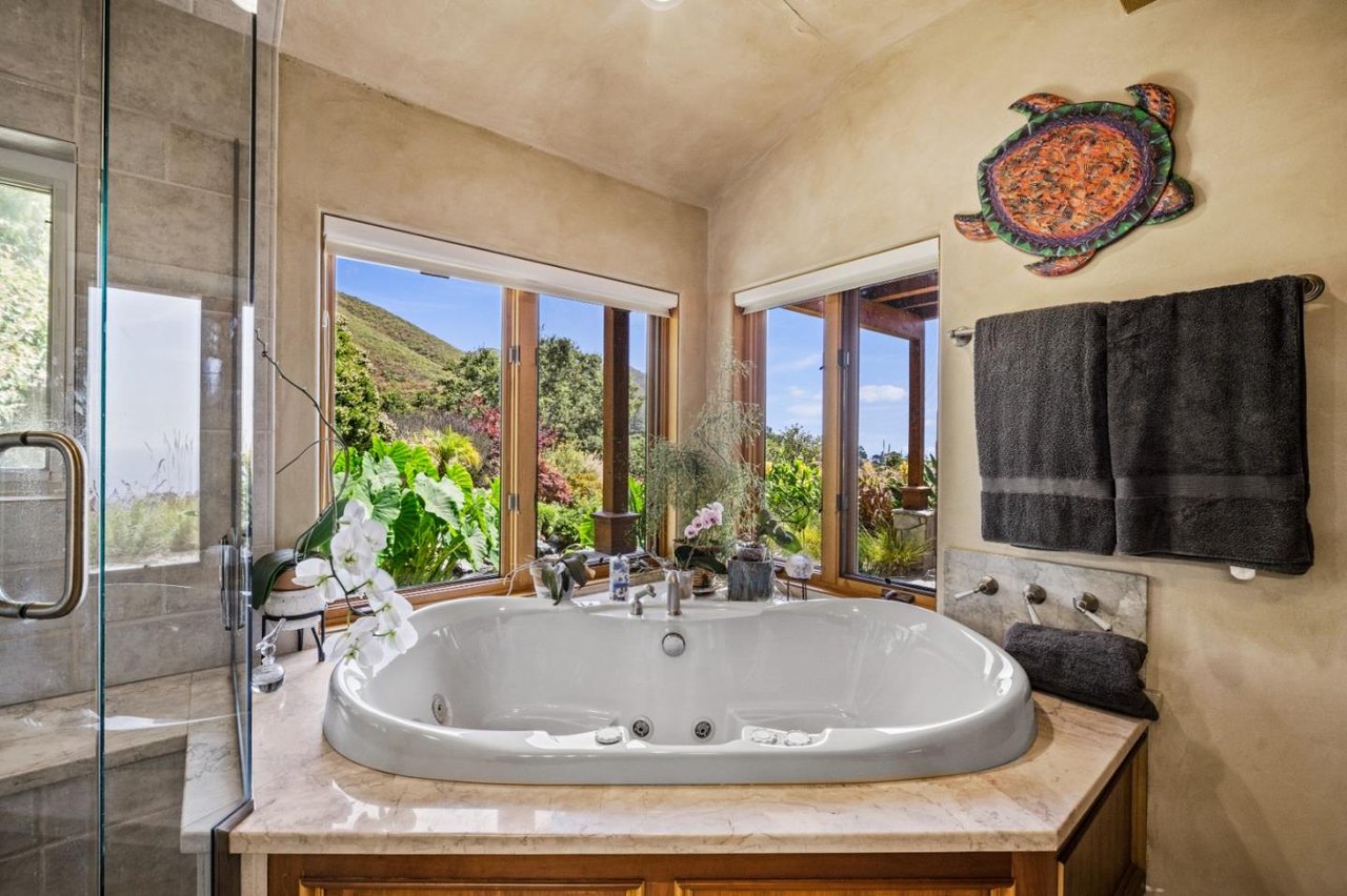 Primary bathroom with soaking tub and garden views in Carmel Highlands home for sale