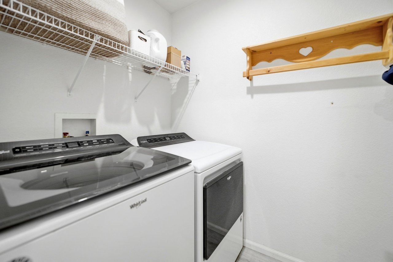 Separate laundry room with shelving
