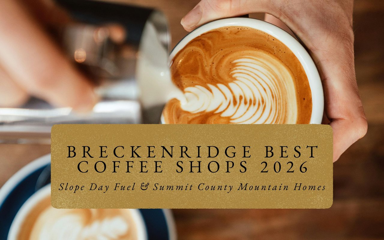 Steaming latte on wooden table outside Breckenridge coffee shop, Peak 8 gondola and snowy slopes visible through steam.