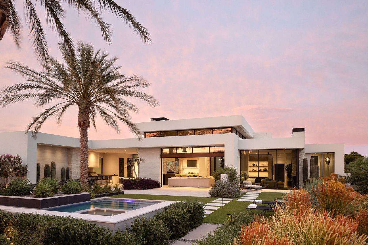 Modern luxury home in Paradise Valley with resort-style backyard, pool, fire feature, and contemporary architecture at sunset.