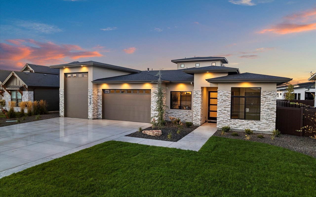 Contemporary craftsman in Star, Idaho, at sunset. Expansive entry. Mix of stone and stucco. Large windows, RV garage.