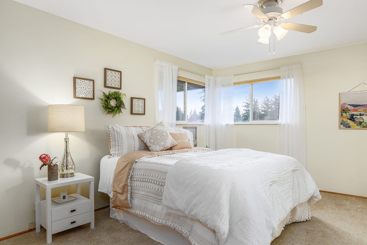 Awaken to natural radiance in the bright primary room featuring charming corner windows, offering a serene retreat filled with light and warmth.