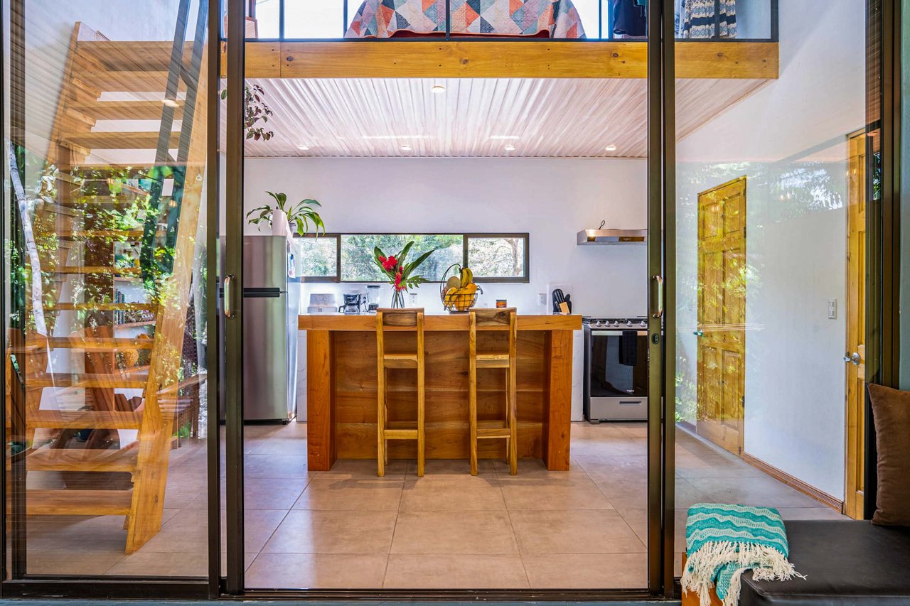 A 1-bedroom loft PERFECT for a couple or an Airbnb rental – plus a HUGE jungle backyard with a year-round river and many magical swimming holes – and a lot of flat land for further development!