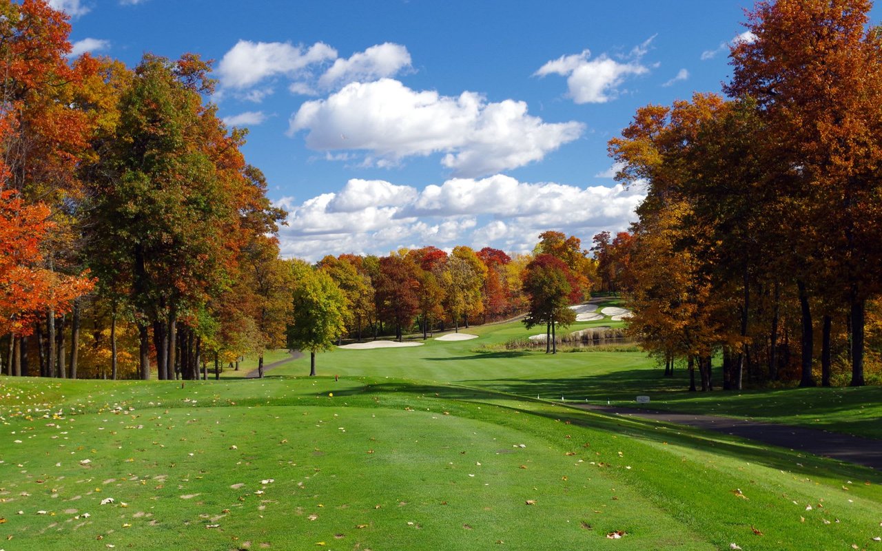Golf course with multicolored, Autumn trees along the course