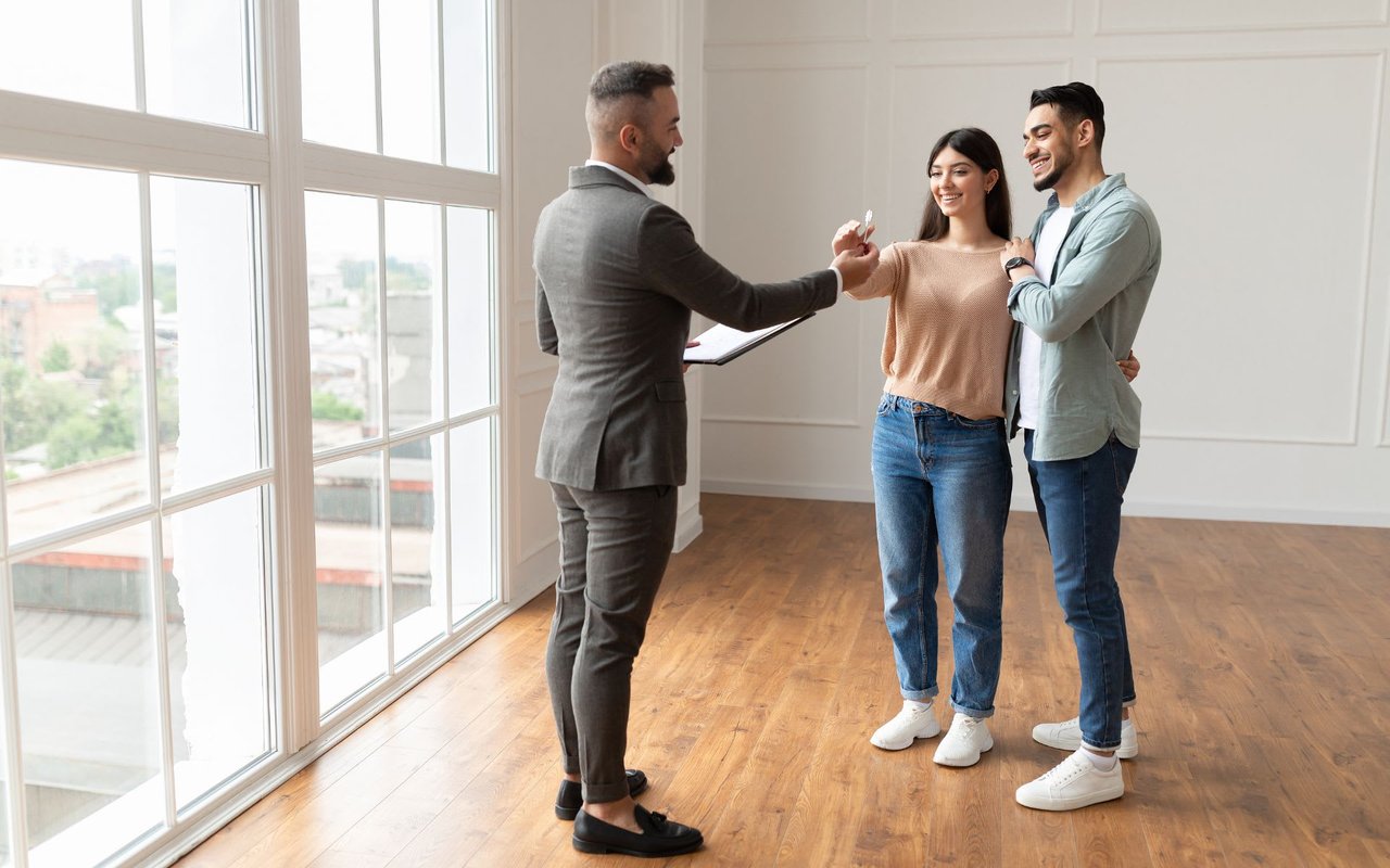 Real Estate Agent Giving Keys to Excited Buyers