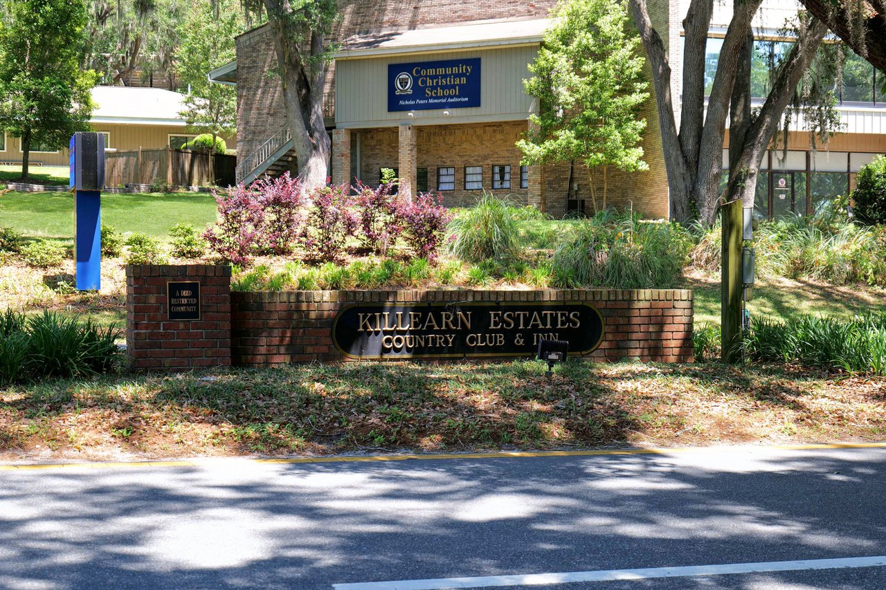 A ground-level view of the entrance sign for "Killearn Estates," indicating the name of the residential community.