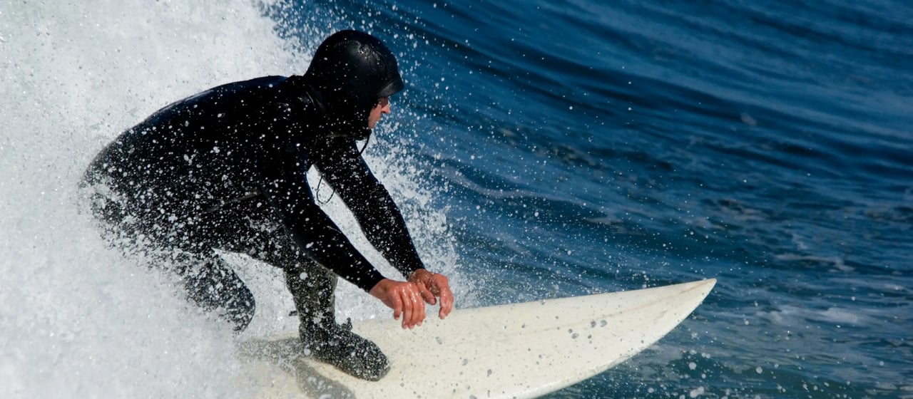 Surfer in a wave off Sunset Blvd in Seaside Oregon