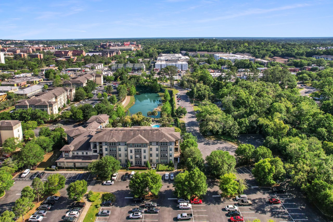 Another aerial view of Campus Circle, highlighting the layout of houses, streets, and green areas, with a water feature in the center.