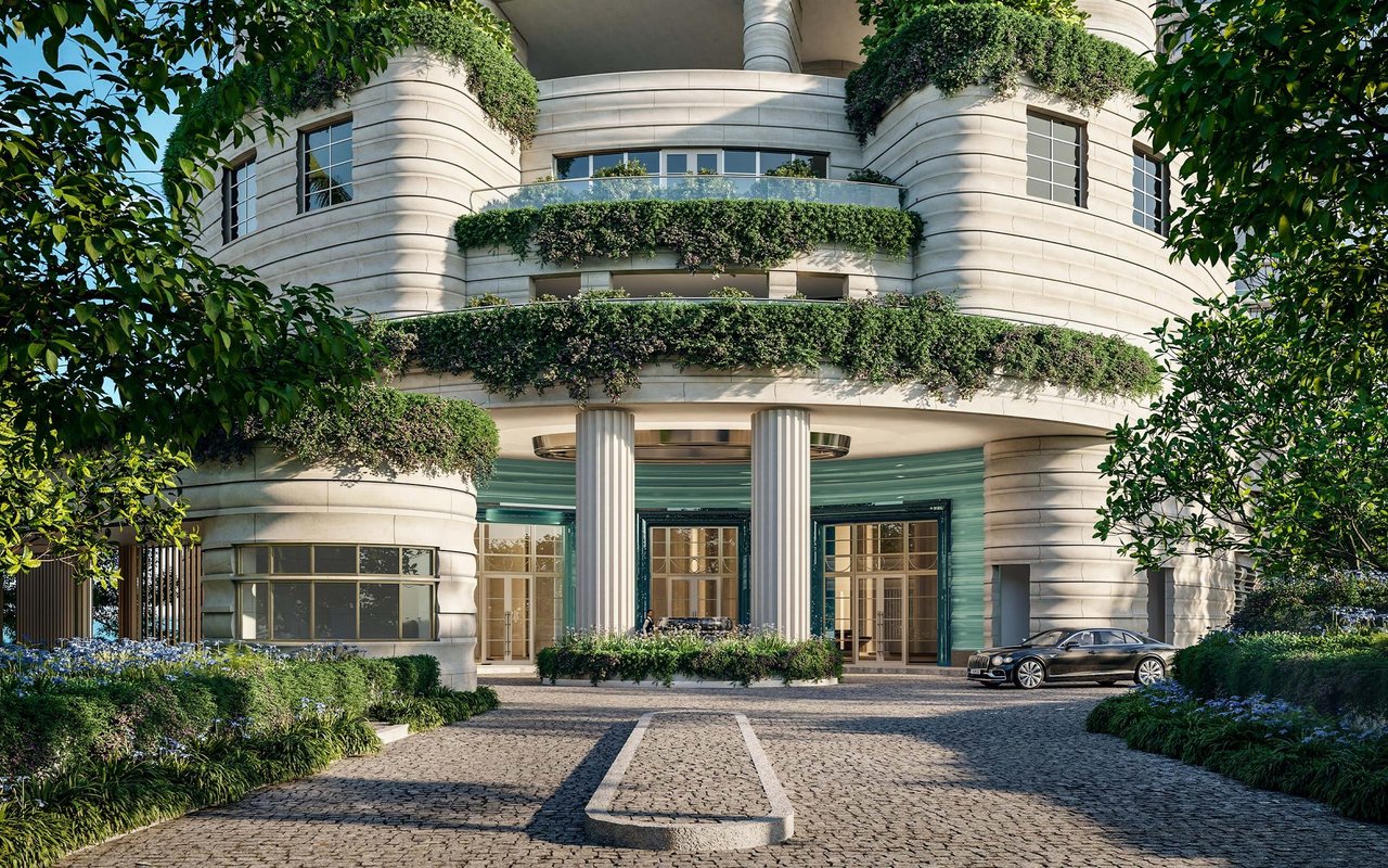 St. Regis Miami Residences entrance with curved stone façades, planted balconies, and a cobblestone driveway.