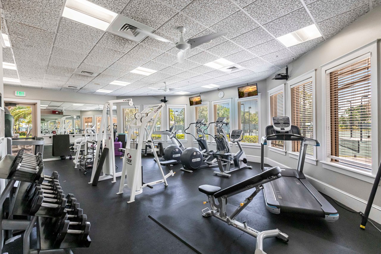 Modern fitness center with cardio and weight equipment at Longshore Lake Naples FL