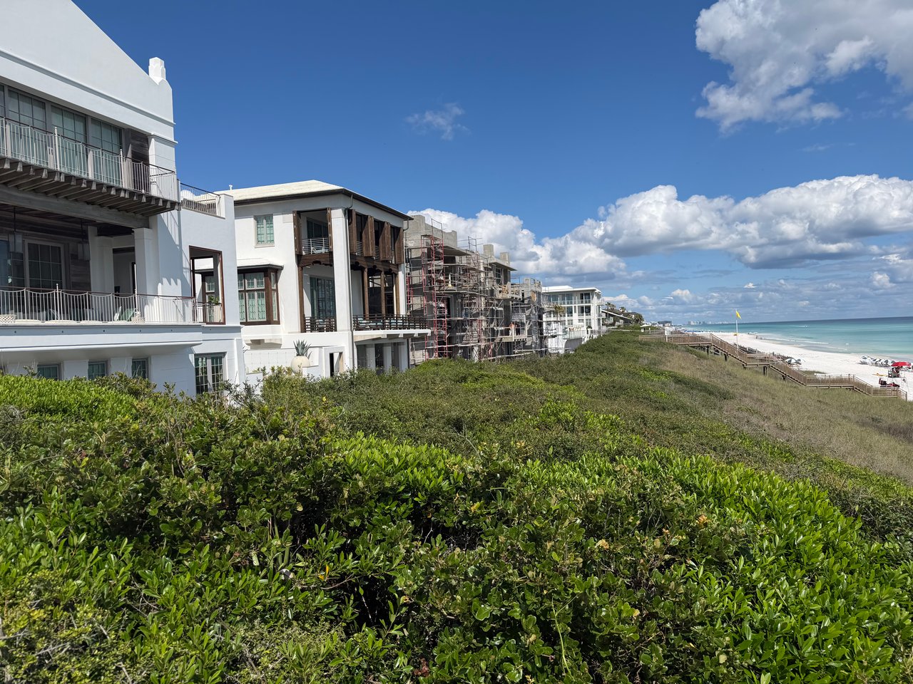 White luxury homes alongside a residential construction site overlooking the beach and ocean in Alys Beach.