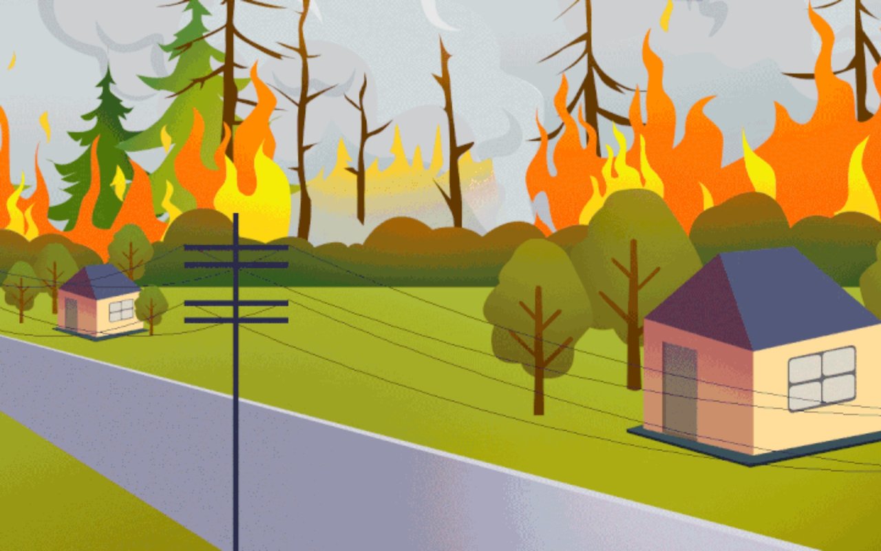 Wildfire flames spread through trees near two houses beside a road.