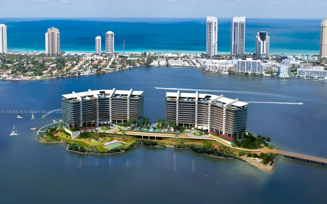 Prive Island’s two waterfront residential towers on a landscaped island, with the Miami skyline beyond.