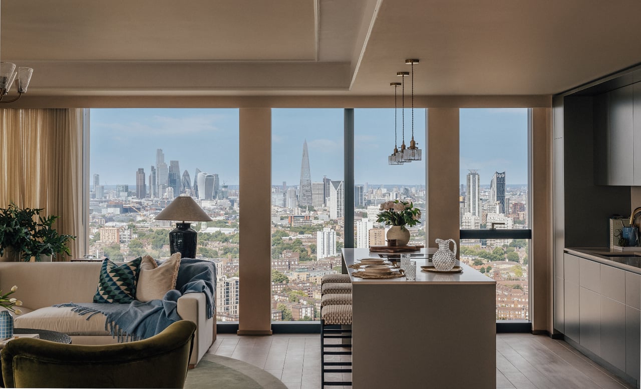 Open-plan living room and kitchen overlooking the London skyline through floor-to-ceiling windows.