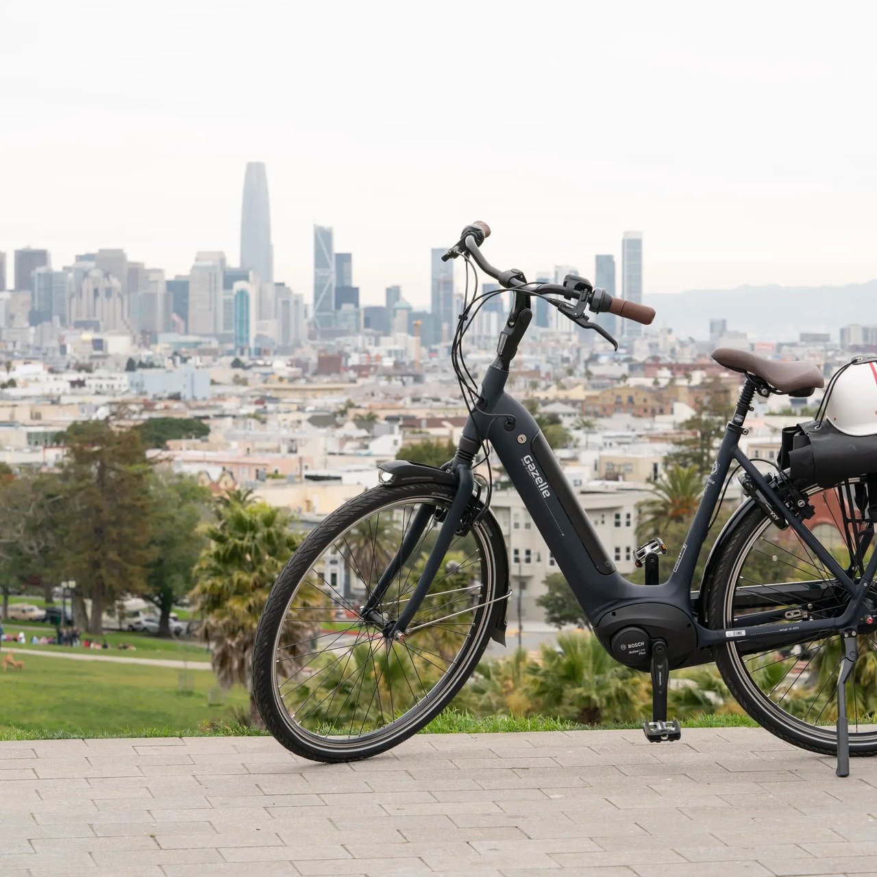 Electric bike parked on hill overlooking San Francisco skyline and cityscape