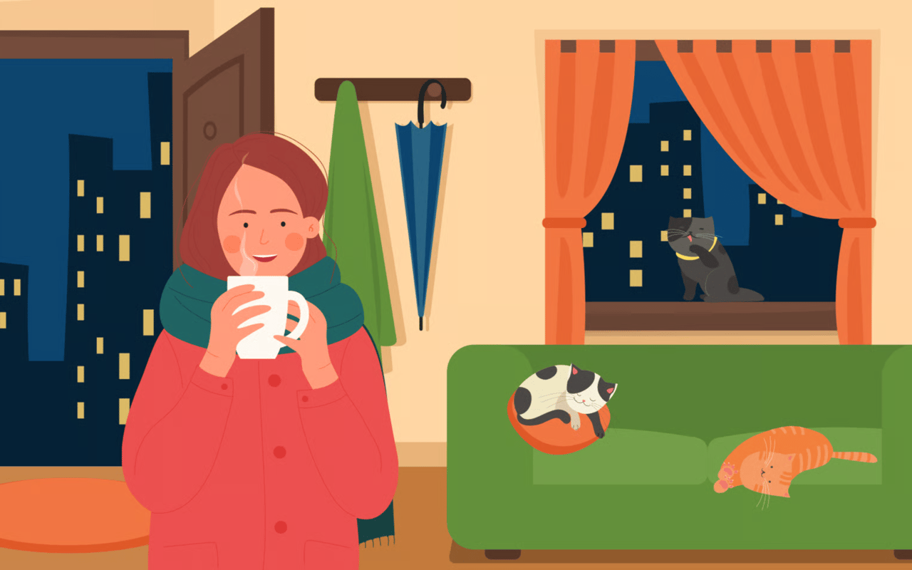 A woman warms herself with a mug while three cats lounge in a cozy home at night.