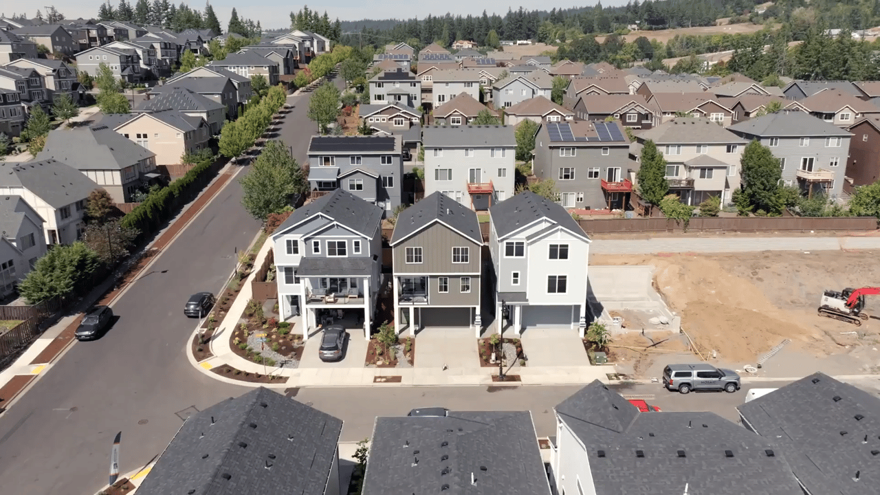 Aerial view of newly built modern homes in a quiet suburban neighborhood in Bethany, Oregon, highlighting clean streets, family-friendly design, and surrounding greenery.