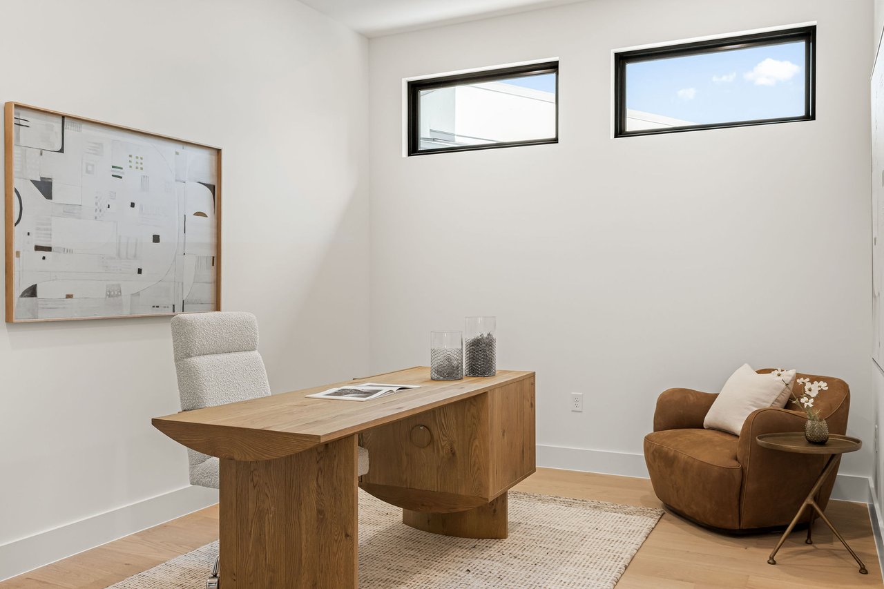 Home office at 1001 Bluebonnet Ln (Zilker, Austin) with a wood desk and wood floors.