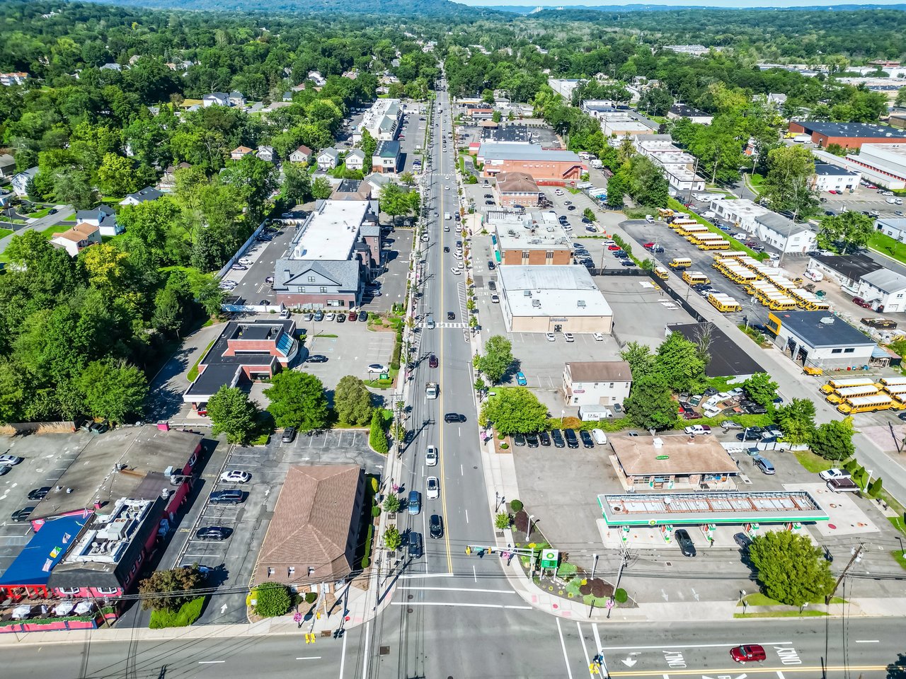Aerial view of Norwood, NJ's main commercial corridor with local shops and school buses
