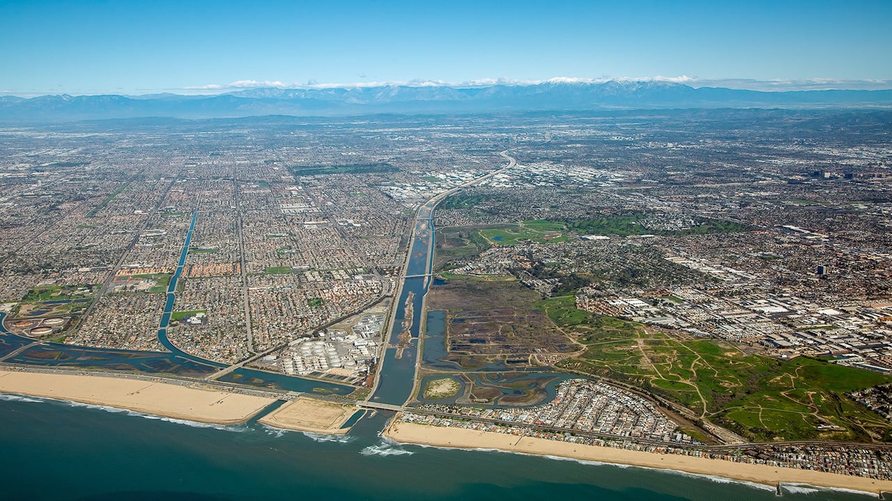 Aerial view of Costa Mesa homes for sale surrounded by palm trees and parks in Southern California