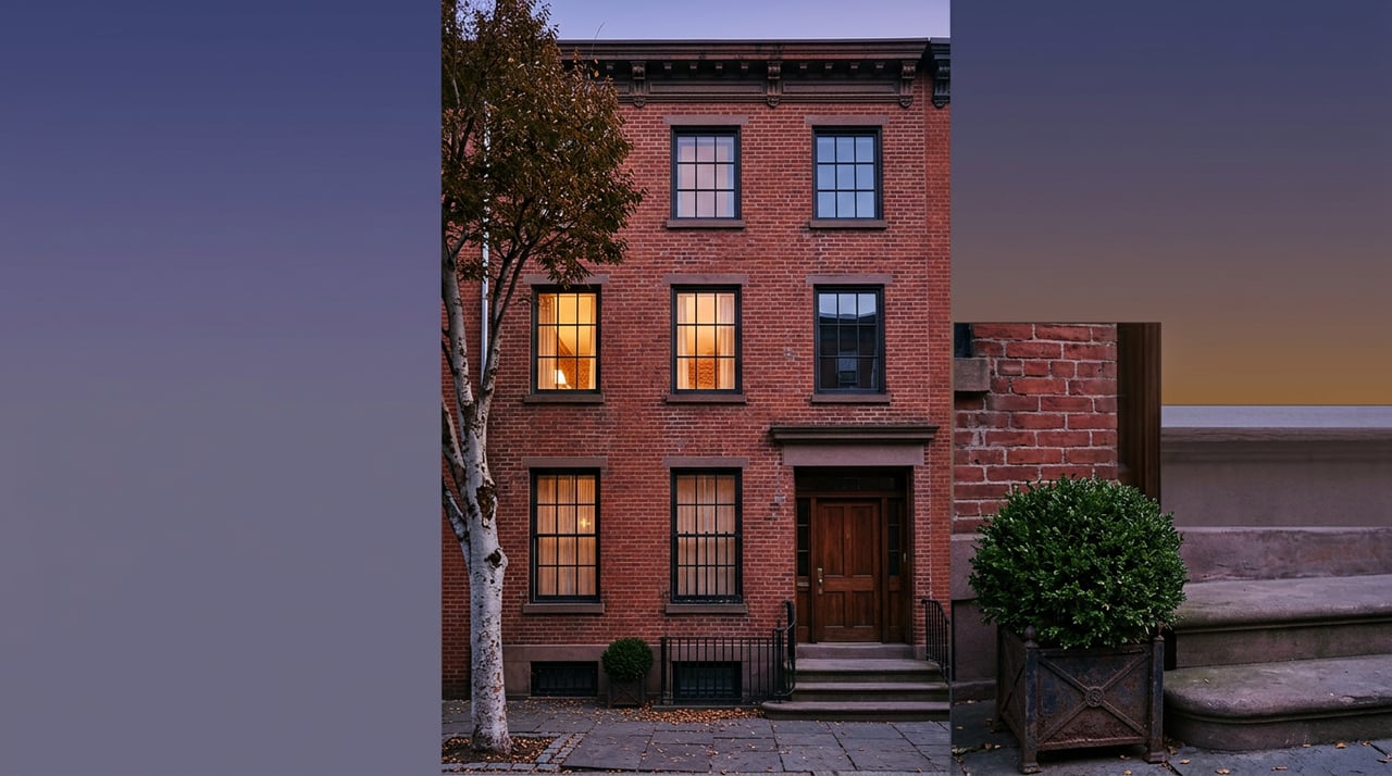Red-brick rowhouse facade with warm light glowing through two upper windows at dusk.