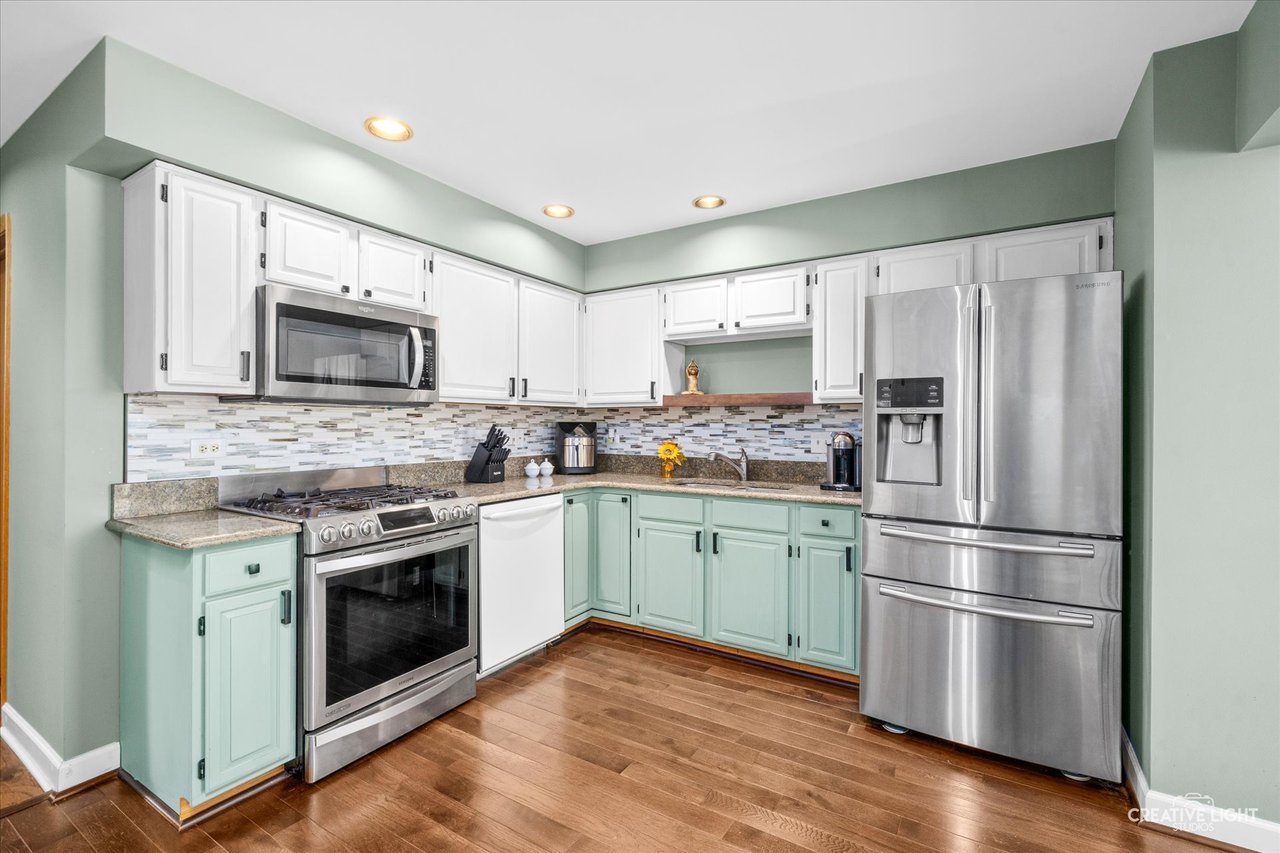 Kitchen with granite counters and mosaic tile backsplash at 8316 Woodland Drive Darien IL