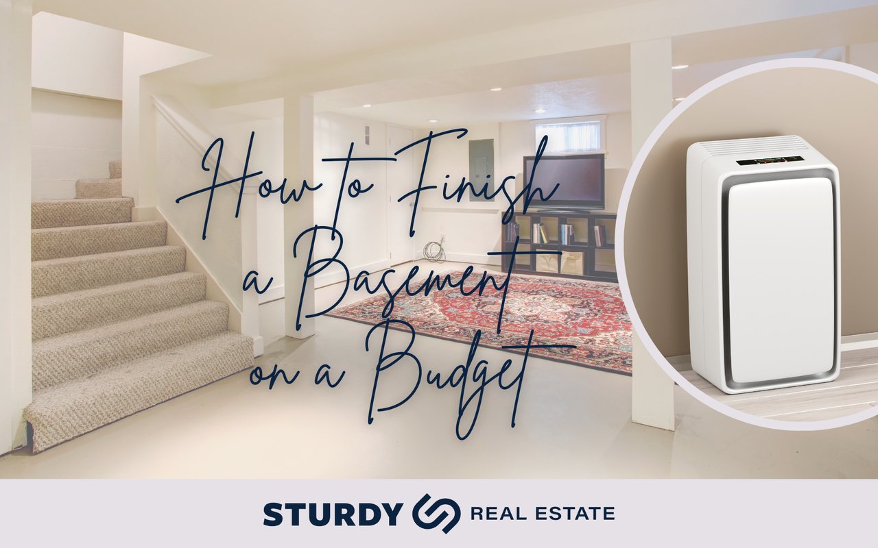Cozy finished basement with carpeted stairs, TV, and rug – blog graphic reading How to Finish a Basement on a Budget | Sturdy Real Estate