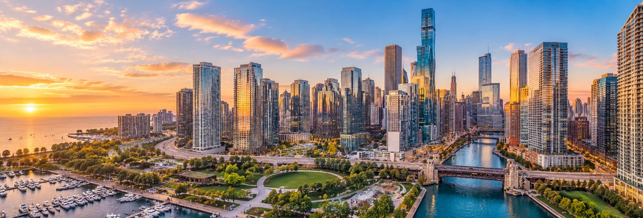 Aerial view of Lakeshore East Chicago, featuring waterfront condominium towers, the Chicago River, DuSable Harbor, and Lake Michigan.