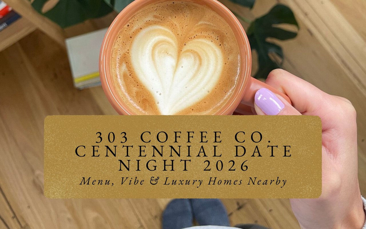 Intricate heart-shaped latte art in white ceramic cup at 303 Coffee Co., steam rising in low light.