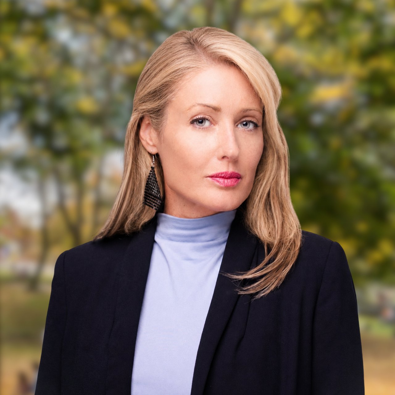 Catherine Hollmann, a blonde woman in a dark blazer and lavender turtleneck.