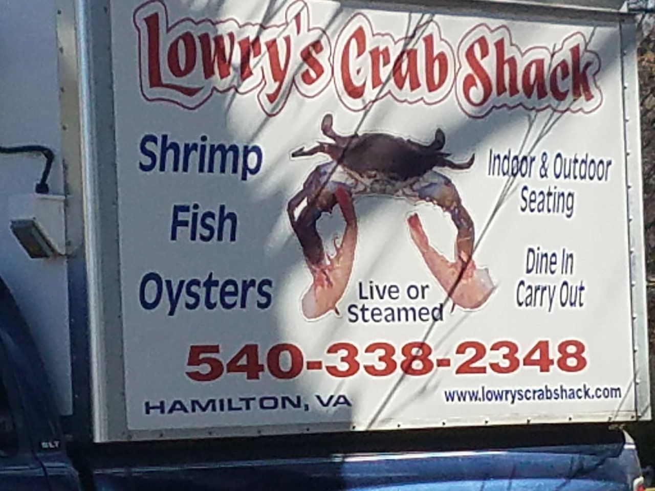 Sign for Lowry's Crab Shack in Hamilton, VA, offering shrimp, fish, and oysters with indoor and outdoor seating.