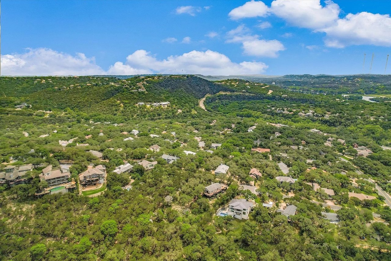 A classic, tree-lined street with scenic elevation changes in the Northwest Hills neighborhood of West Austin.