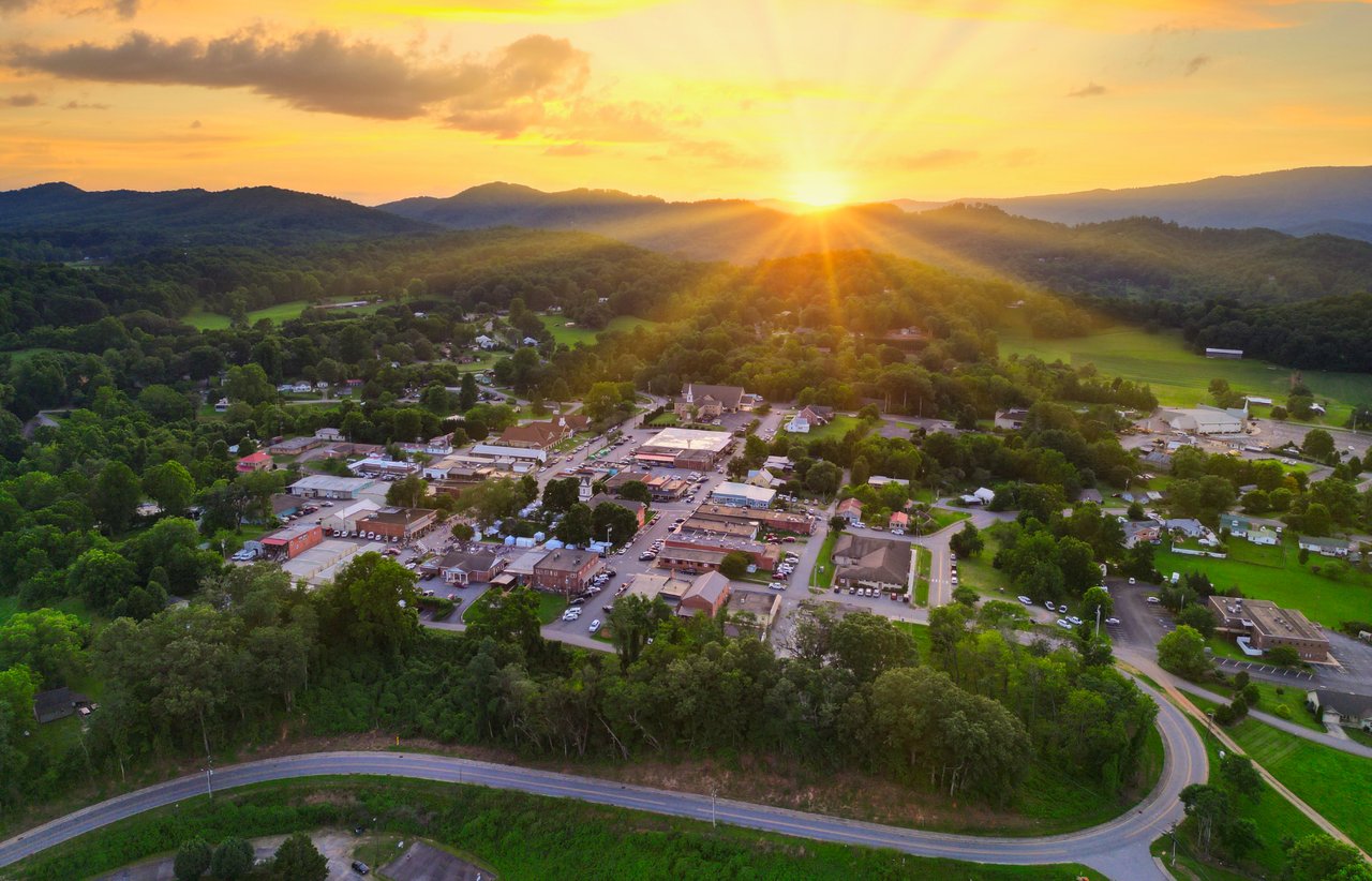 Hayesville nestled among wooded mountain ridges at sunset.
