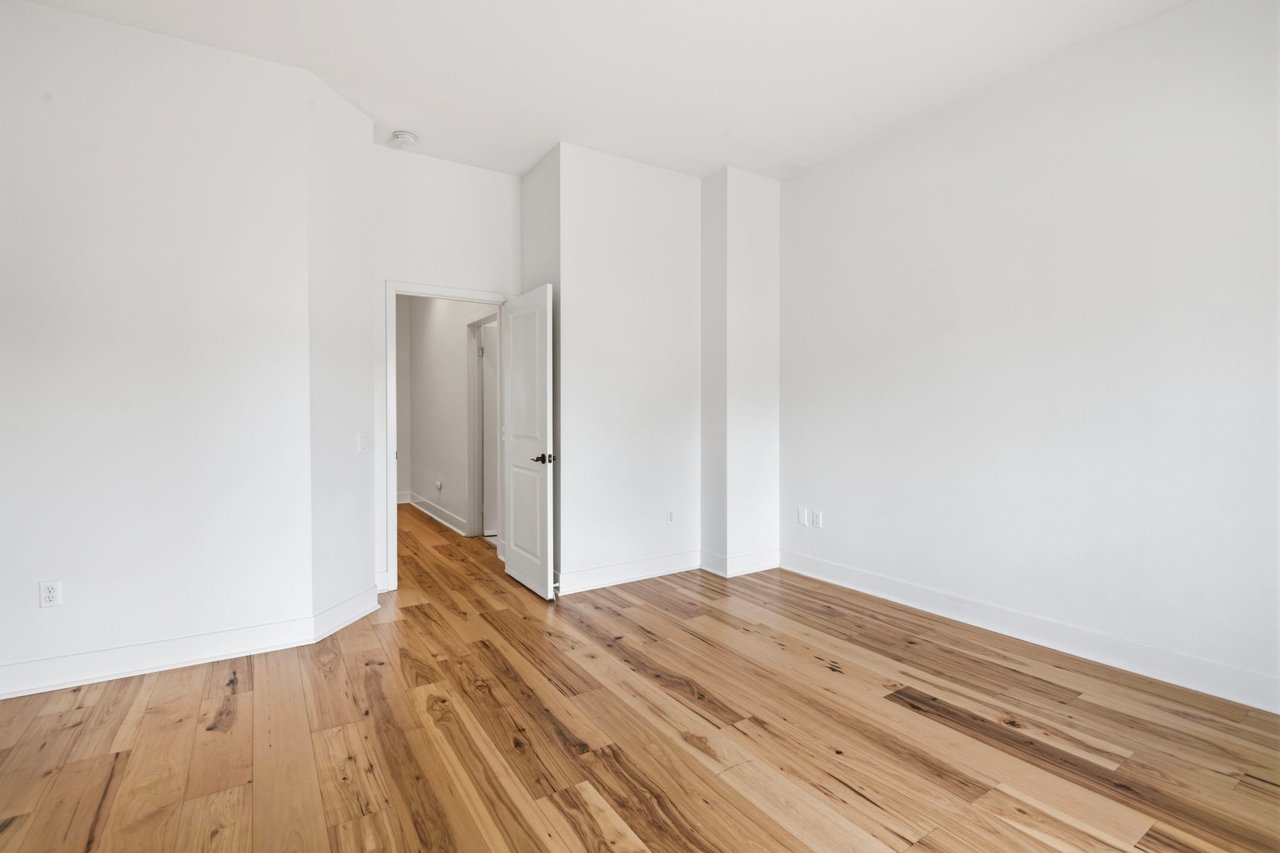 Second bedroom with hardwood floors, recessed lighting, and closet space