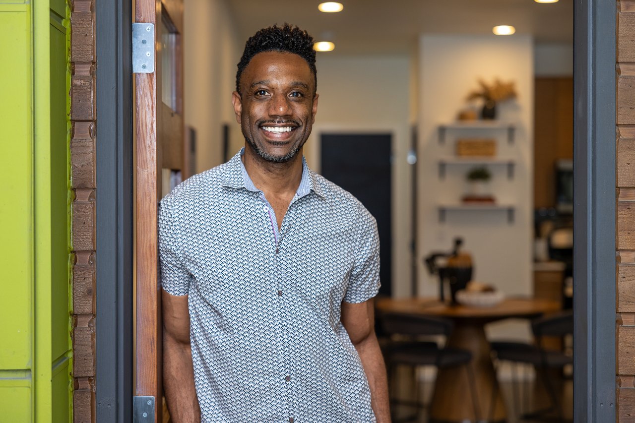 Realtor, Rocky Flowers in townhome doorway