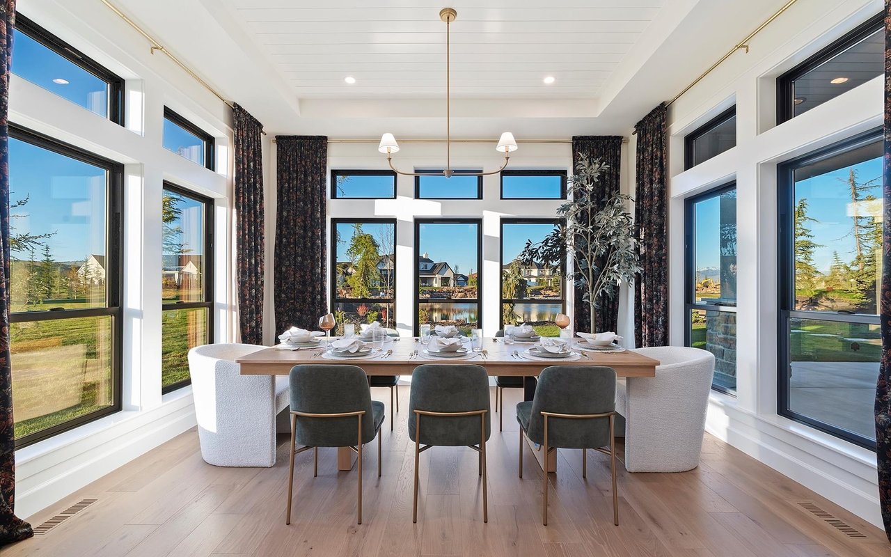 Dining room with 7 floor-to-ceiling windows overlooking the lake