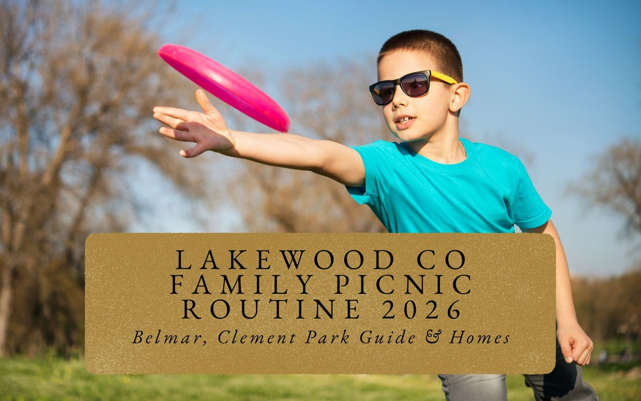 Family frisbee game on lush green field at Bear Creek Lake Park picnic area, mountains distant.