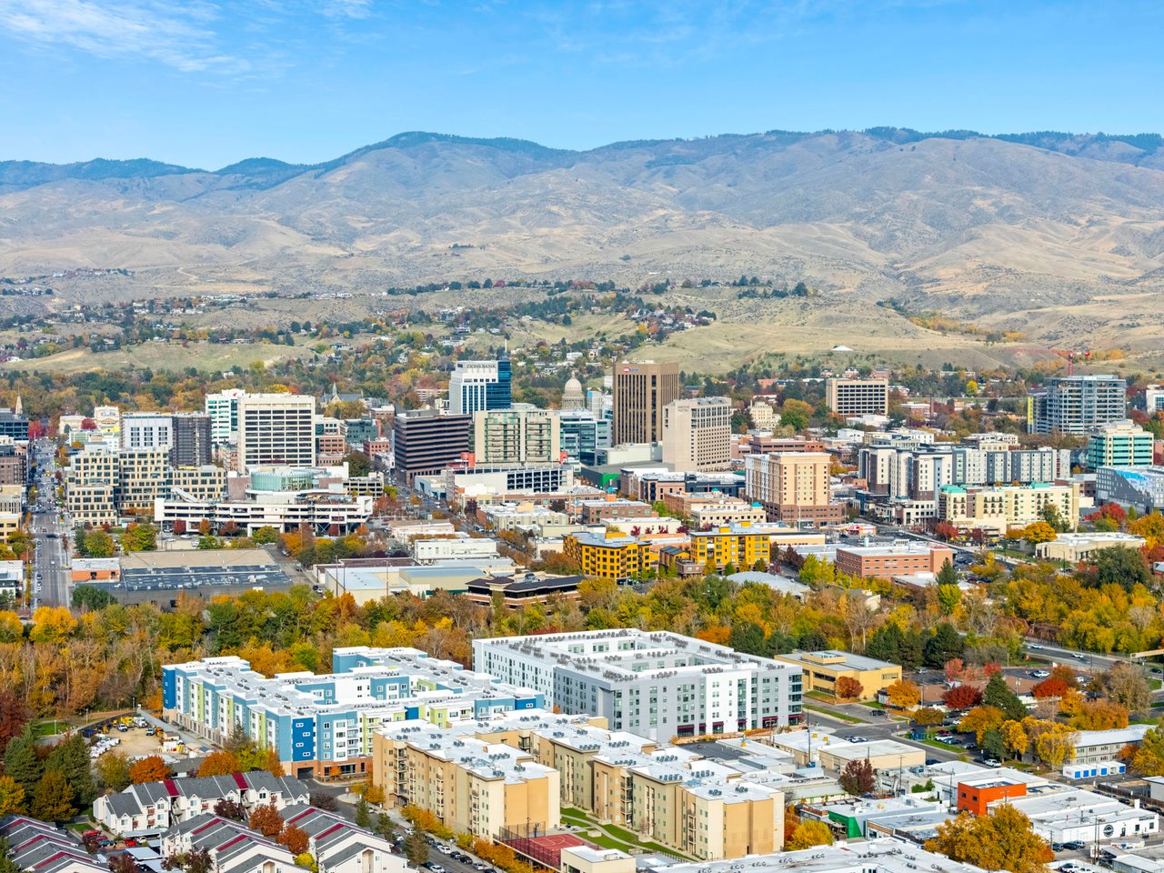 Downtown Boise and autumn trees, with the foothills stretching across the background.