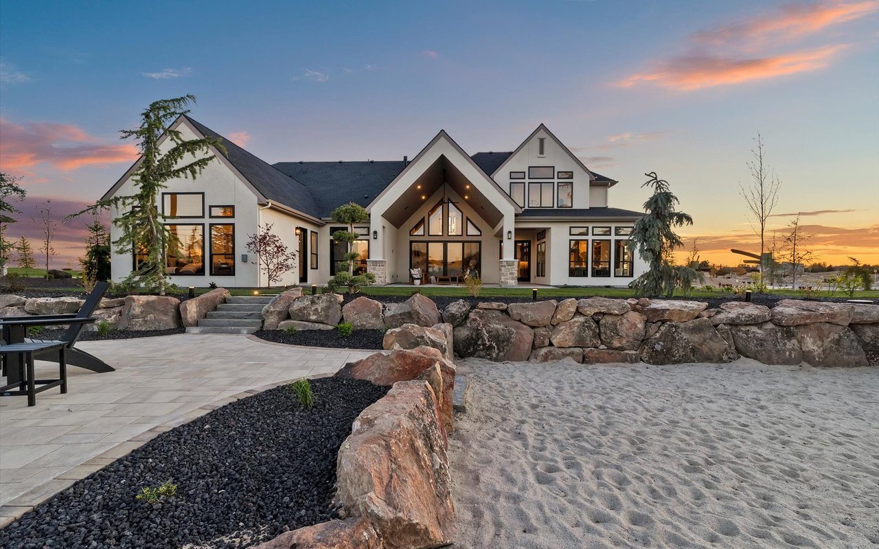 Back exterior of the house from the lake - half patio and half beach