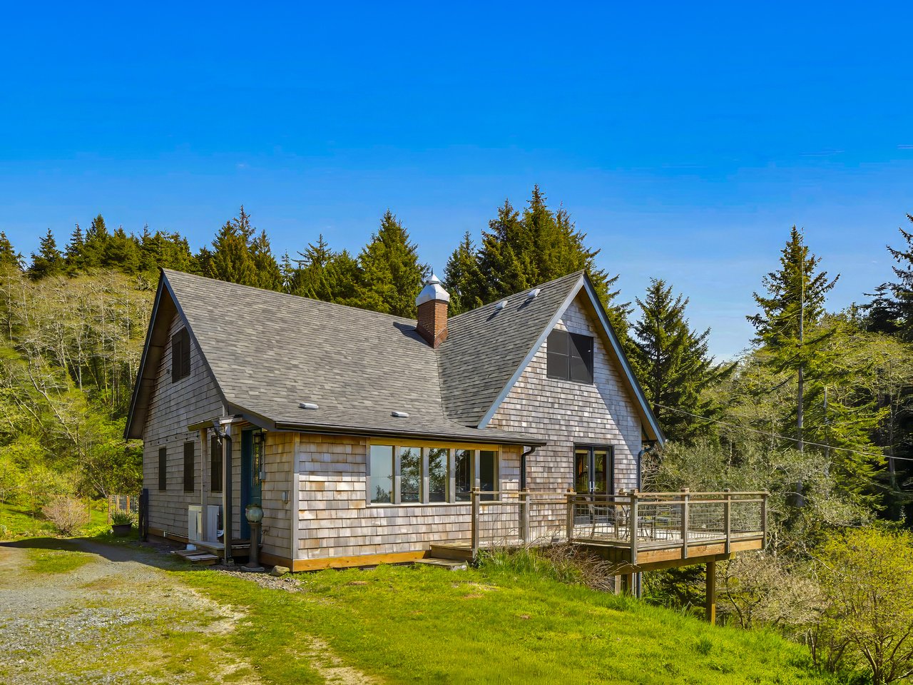 Exterior view of the sold restored farmhouse at 31205 N Hwy 101 near Wheeler and Rockaway Beach, Oregon
