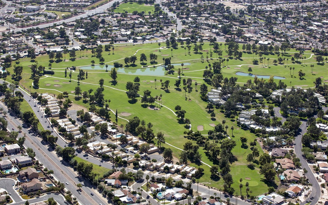 Aerial view of a golf course with ponds and homes in Litchfield Park.