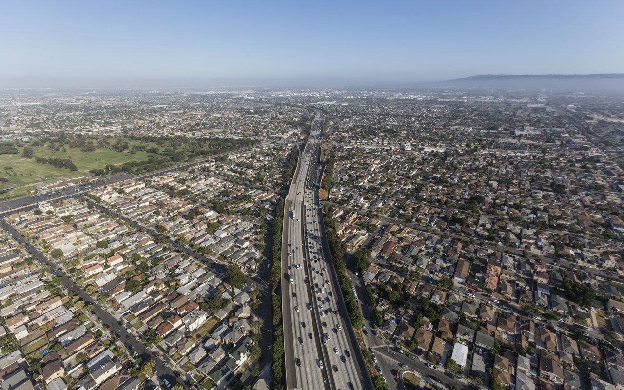 Aerial view of Lawndale with a freeway running through dense residential blocks.