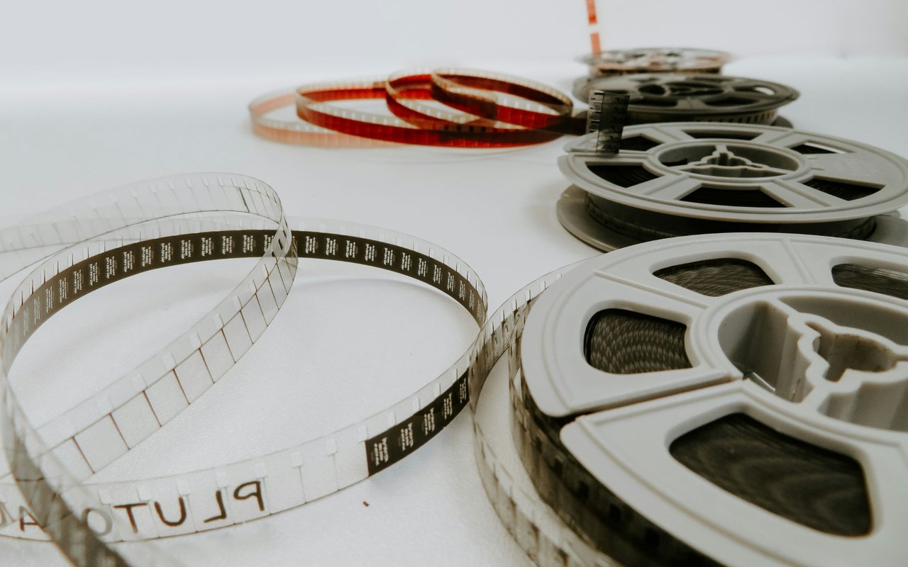 Film reels with loose strips of motion-picture film.
