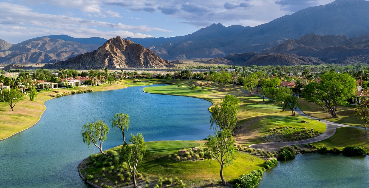 Aerial view of PGA West golf courses and homes below the Santa Rosa Mountains in La Quinta, California
