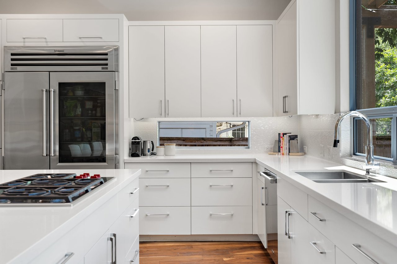 Kitchen at 34 Margranita Crescent, Tarrytown, Austin, TX, with a Sub-Zero refrigerator, gas cooktop, and quartz counters.