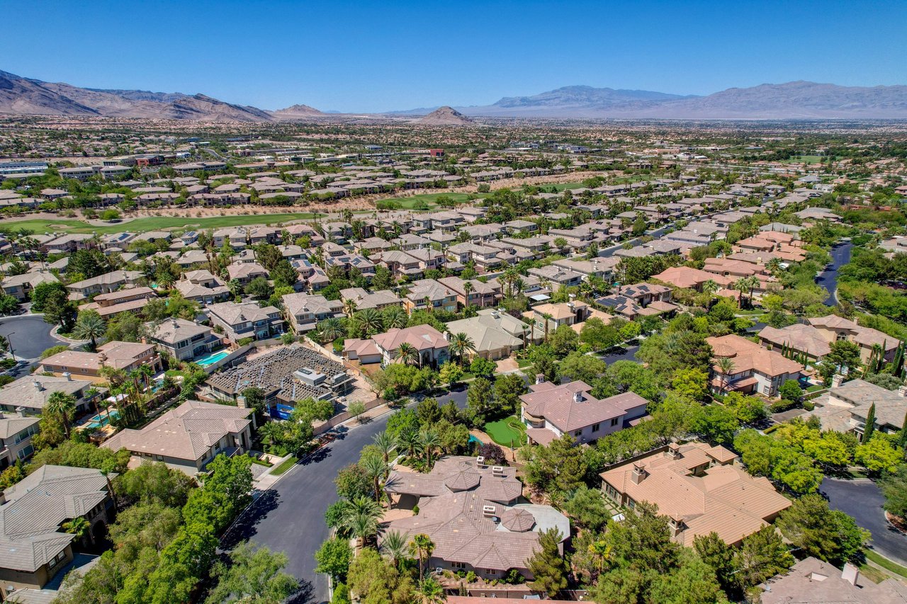 Tile-roofed estate homes among mature trees and golf greenery in west Las Vegas